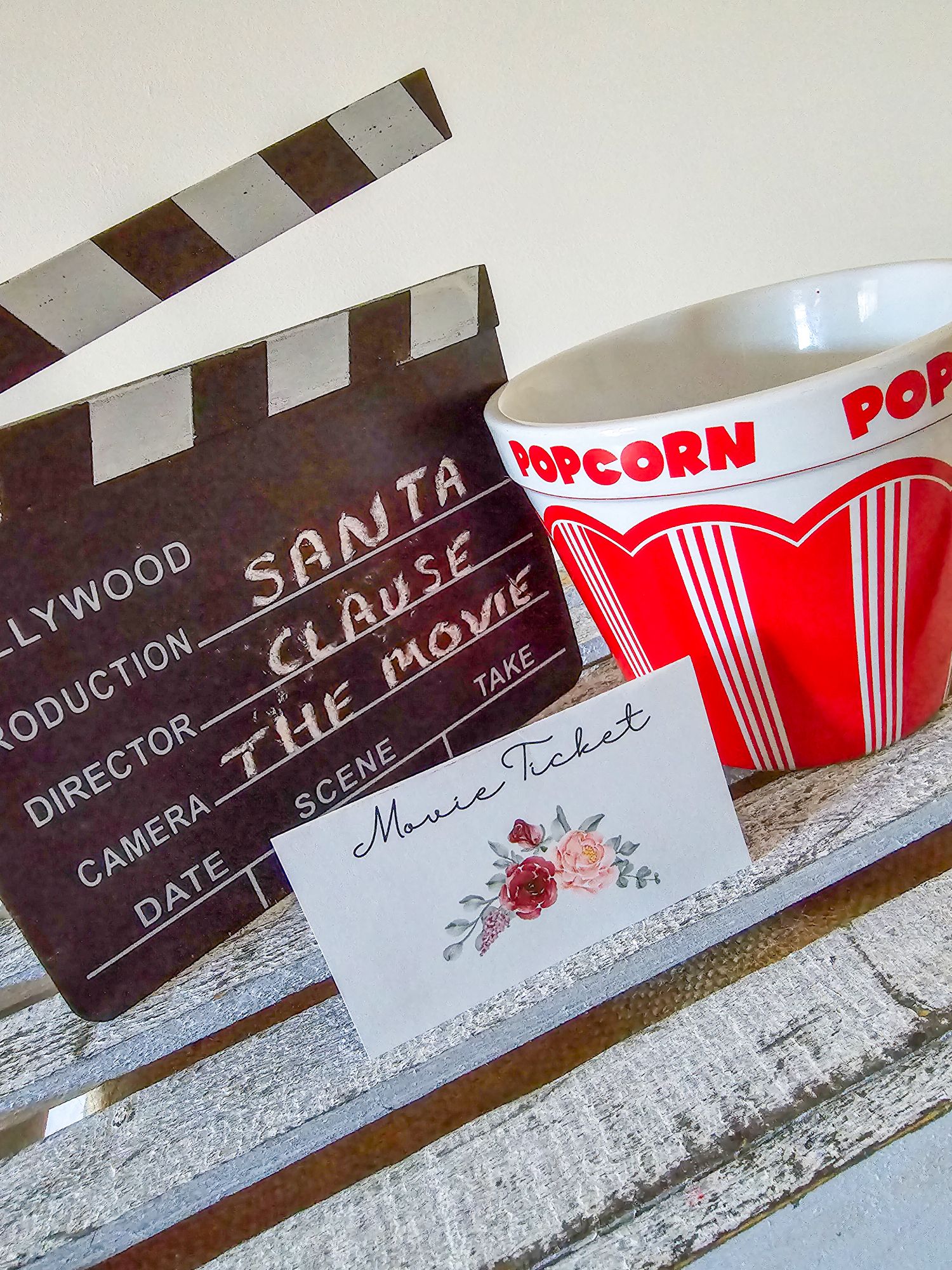 Movie-themed Price is Right setup with popcorn bucket, clapper board, and floral label