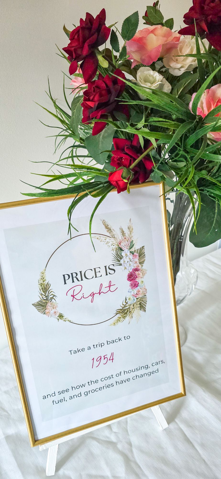 Price is Right framed sign with floral vase beside it