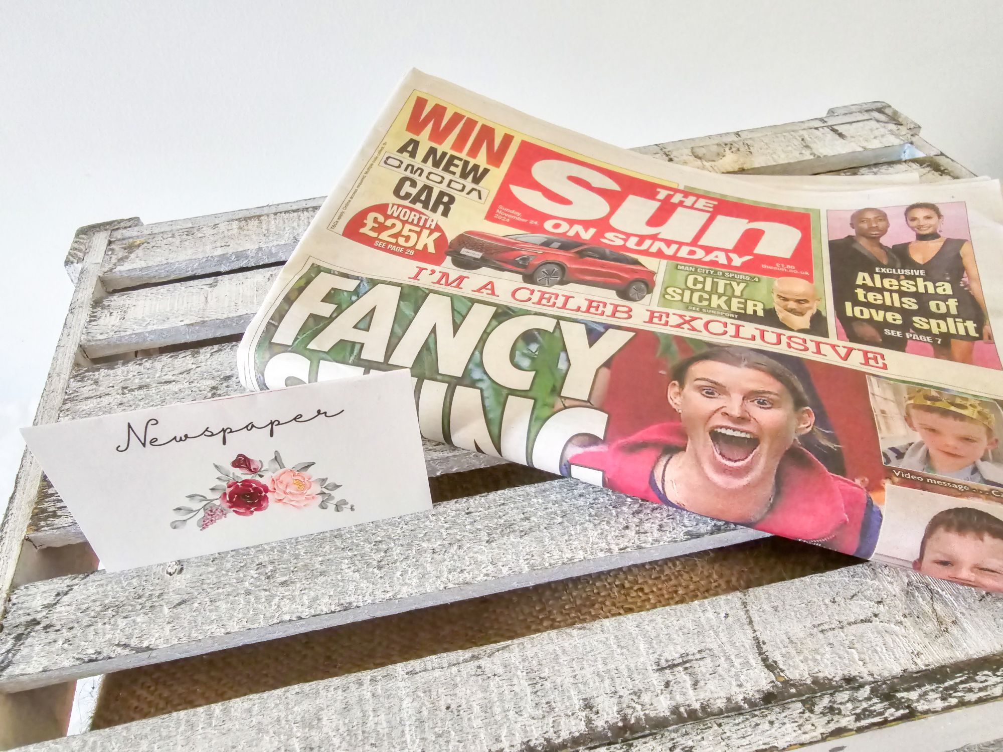 The Sun on Sunday newspaper with floral “newspaper” label on white crate