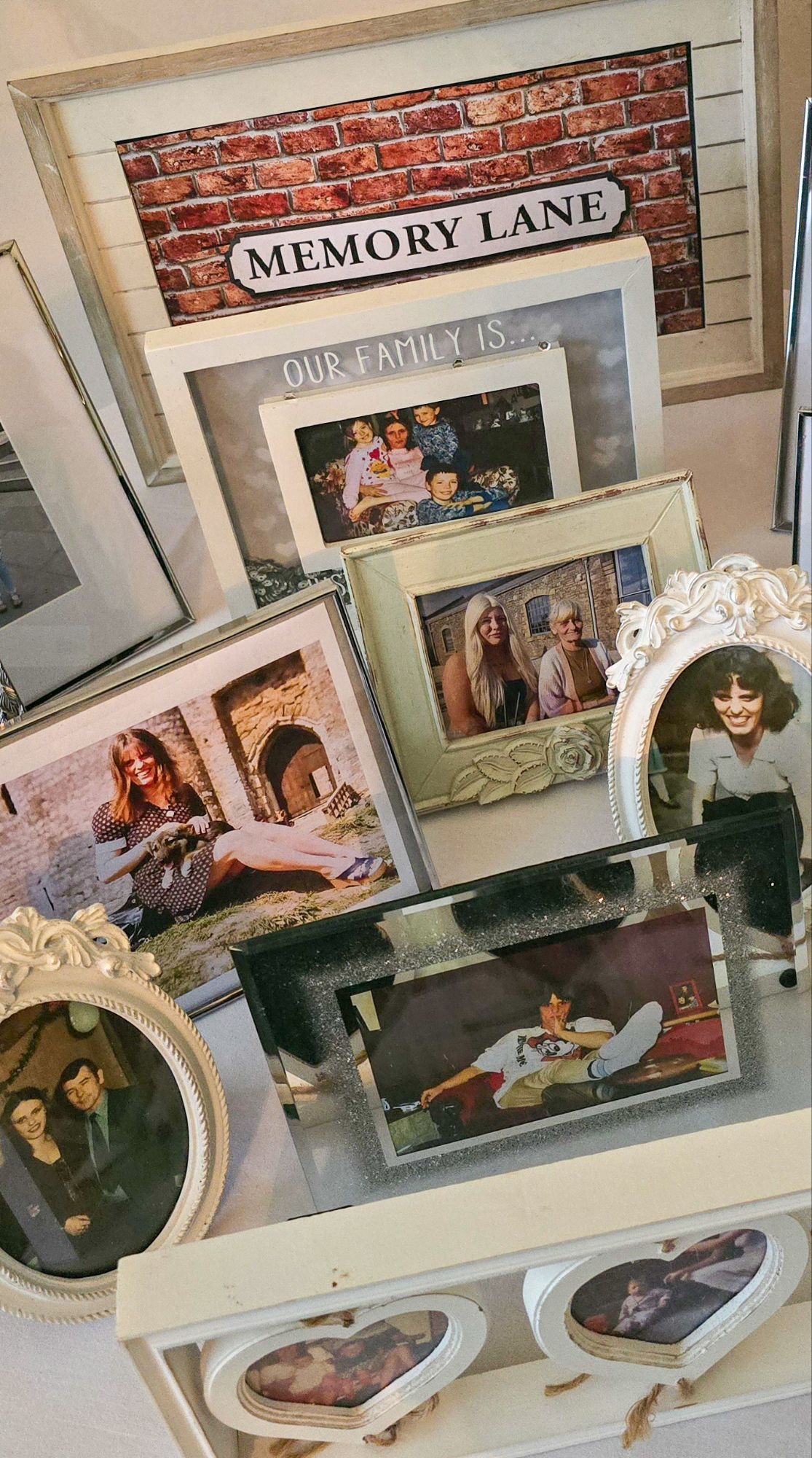 Memory Lane photo display with themed poster and framed photos of Mum through the decades