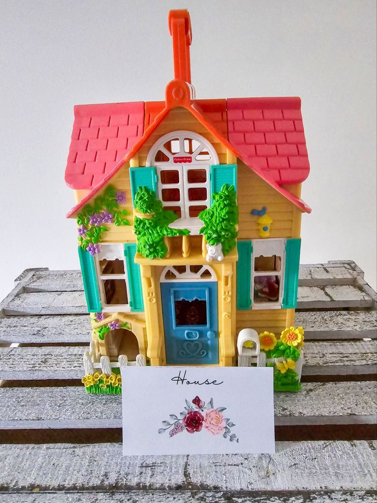 Yellow toy house with floral “house” label for Price is Right game