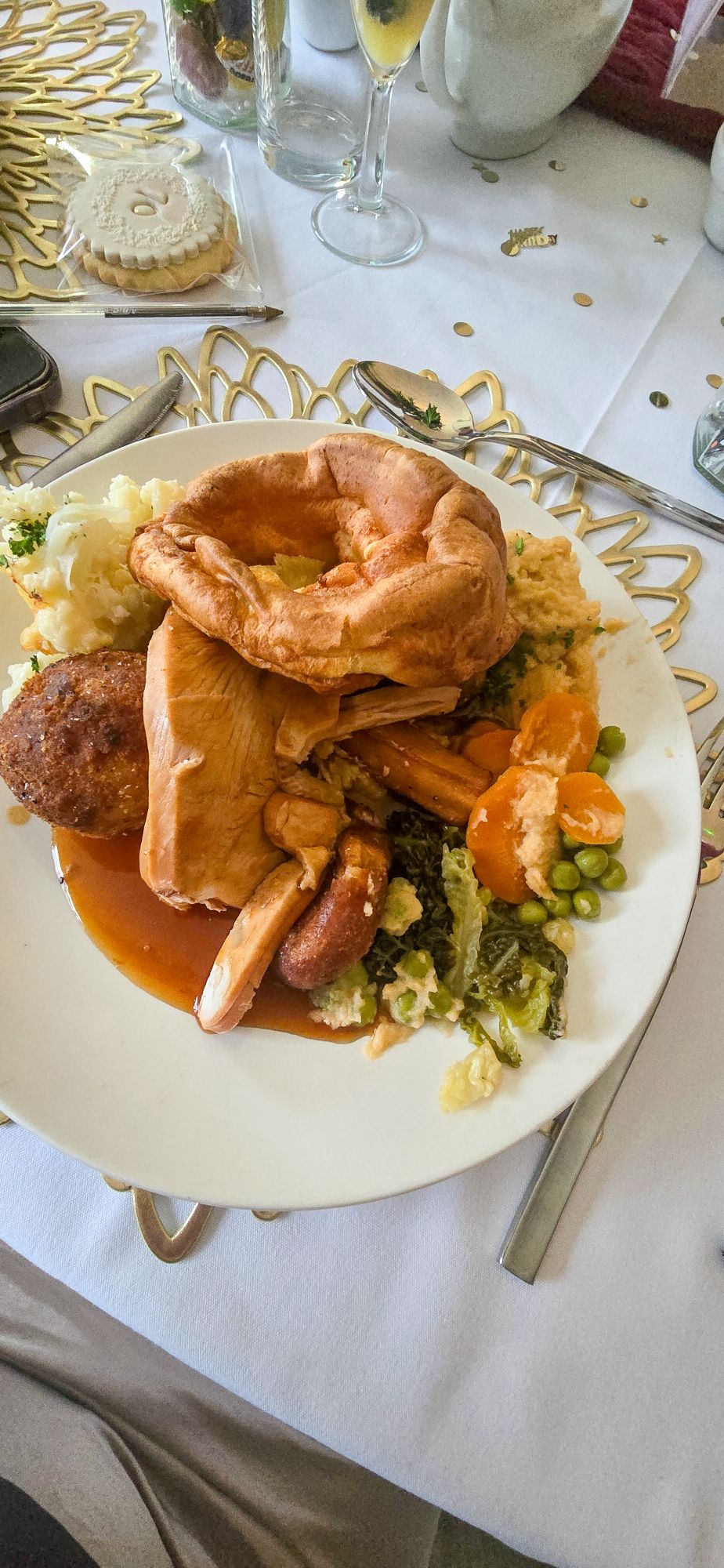 Sunday roast dinner with Yorkshire pudding, chicken, mash, and vegetables